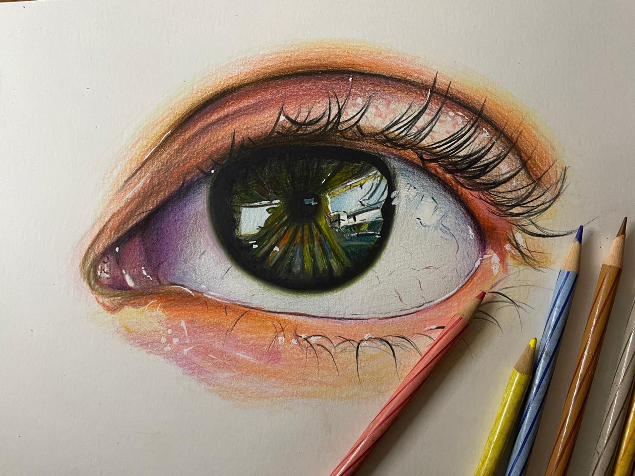 Coloured pencil drawing of a human eye with a landscape reflected in the iris